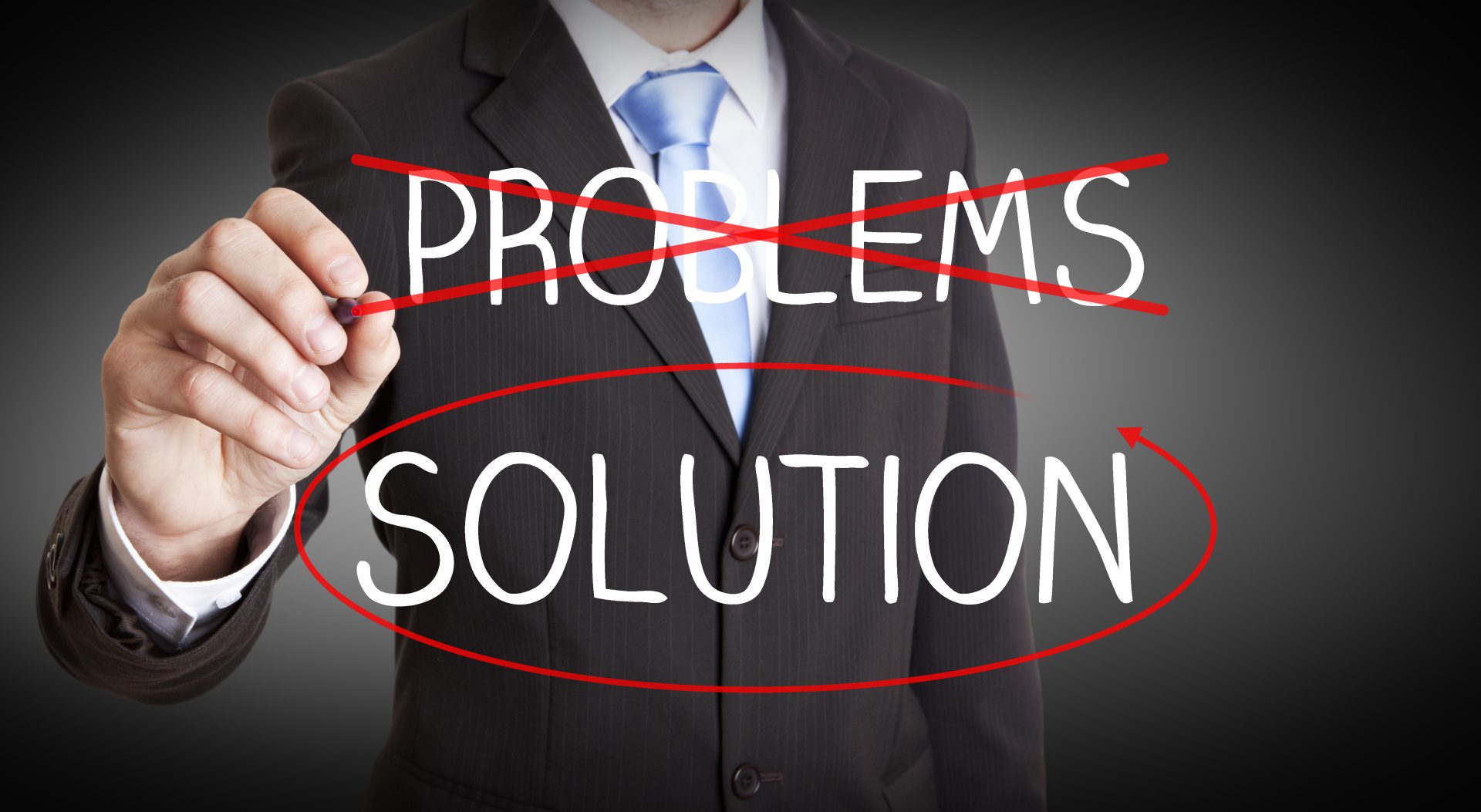 A man in a suit and tie writing " problems " and " solution ".